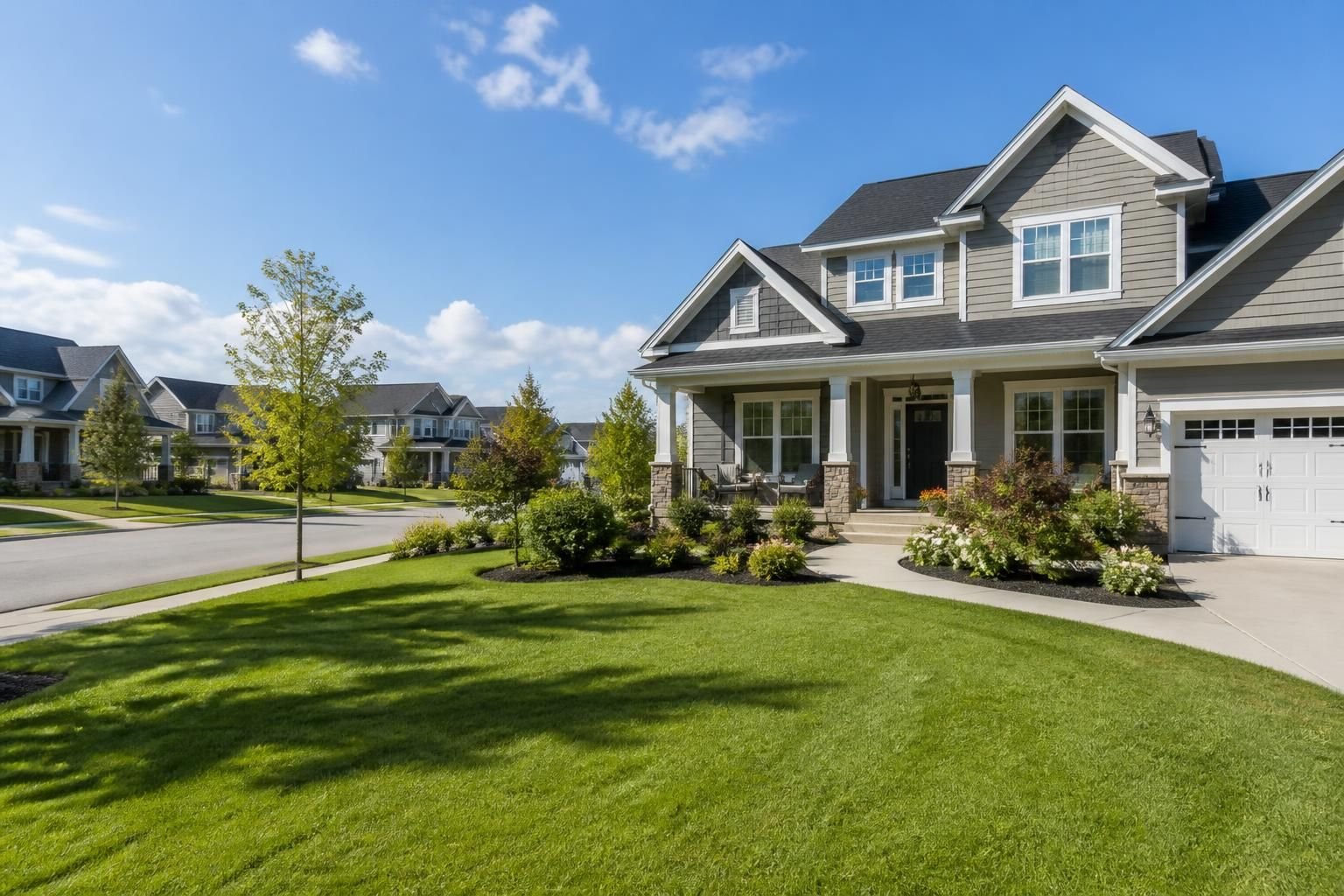 Spacious neighborhood with manicured lawns and bright daylight.